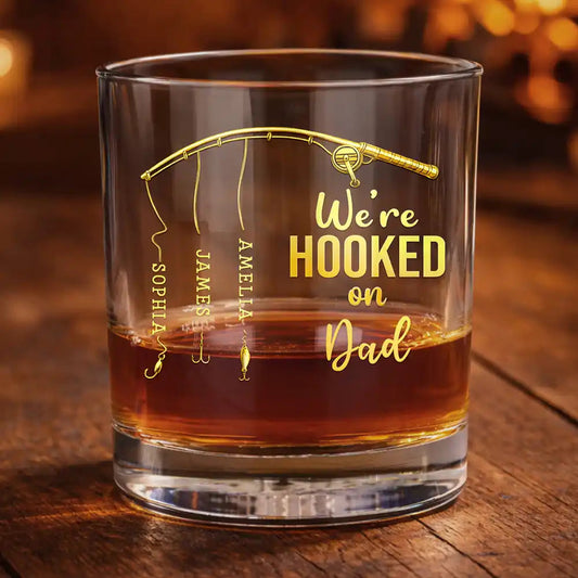 Personalized fishing whiskey glass engraved with Hooked on Dad and custom kids names on fishing lines