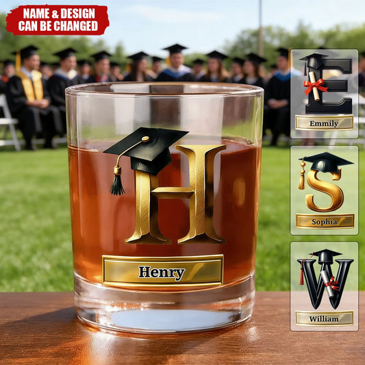 Personalized graduation whiskey glass with custom gold initial and black grad cap design for graduates
