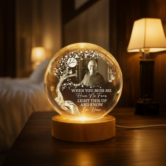 Personalized memorial crystal ball night light with photo and tree design on an illuminated wood base