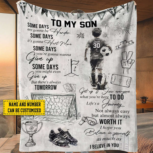 Personalized soccer blanket for boys featuring a custom name and jersey number next to an inspiring sports quote.