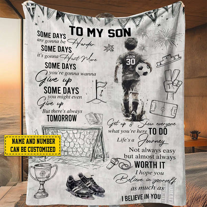 Personalized soccer blanket for boys featuring a custom name and jersey number next to an inspiring sports quote.