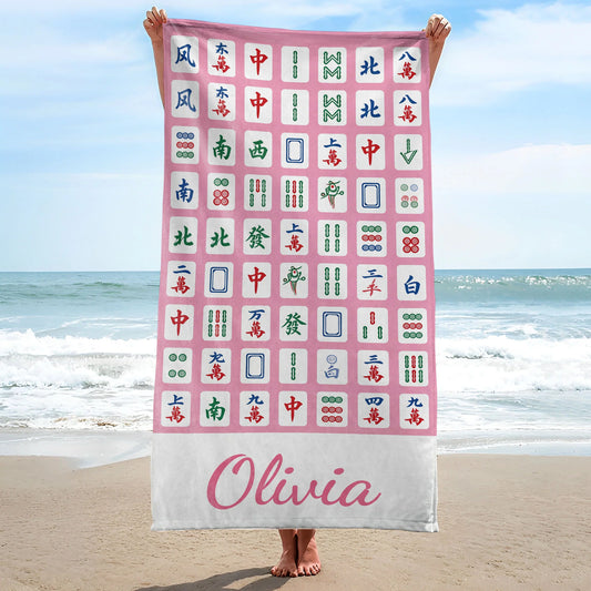 Personalized mahjong beach towel in vibrant pink with custom name print for summer pool days