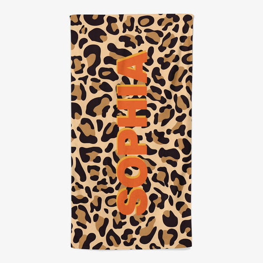 Custom monogram beach towel with personalized name over a trendy leopard print pattern