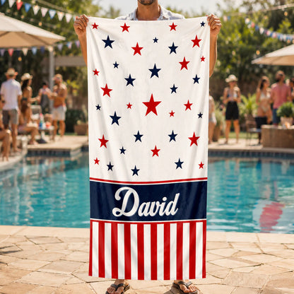 Personalized patriotic beach towel with custom name David featuring red and blue stars and stripes design by a pool