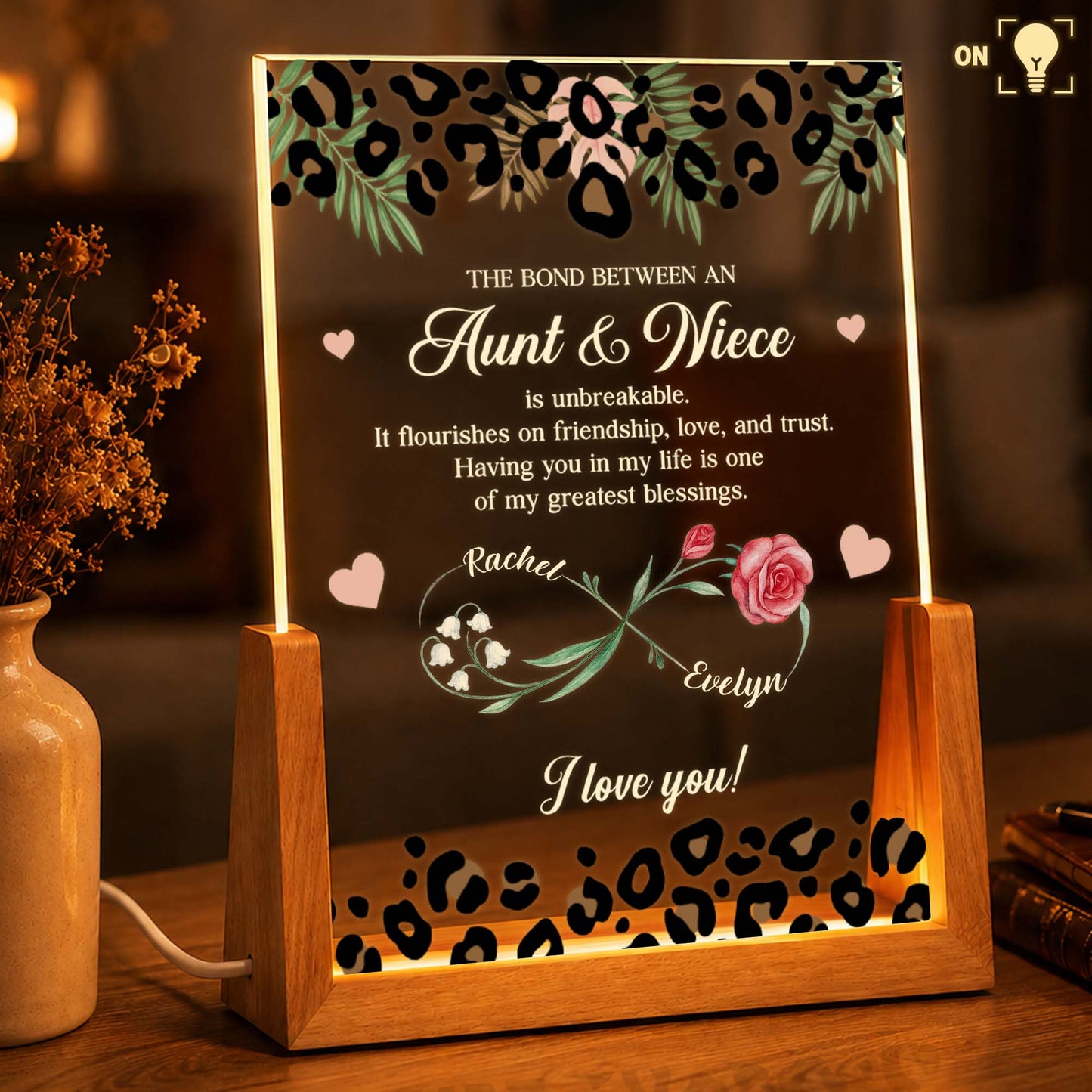 Personalized aunt and niece night light with custom birth flowers and leopard print on a warm LED wooden base