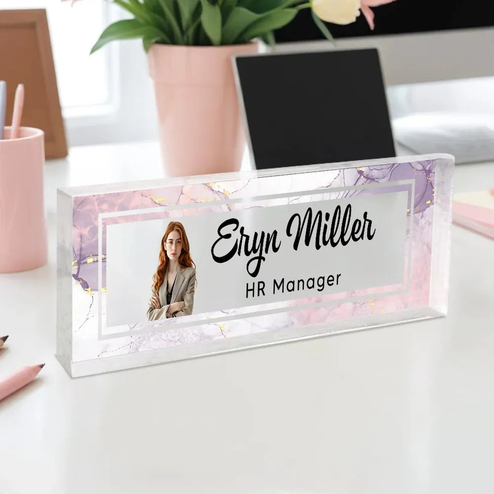 Personalized desk name plate with marble design and custom name text on a warm glowing wooden LED light base