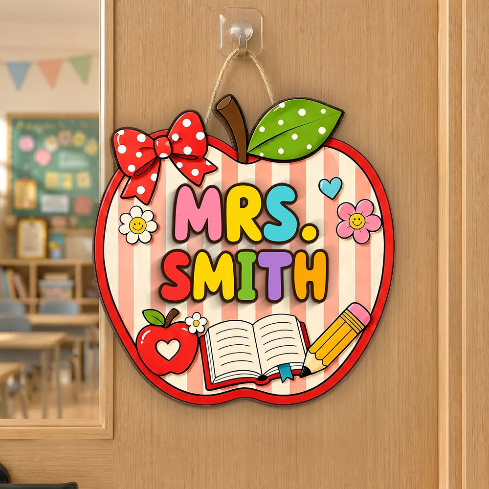 Personalized teacher welcome door sign featuring a colorful apple shape with custom name for classroom decor