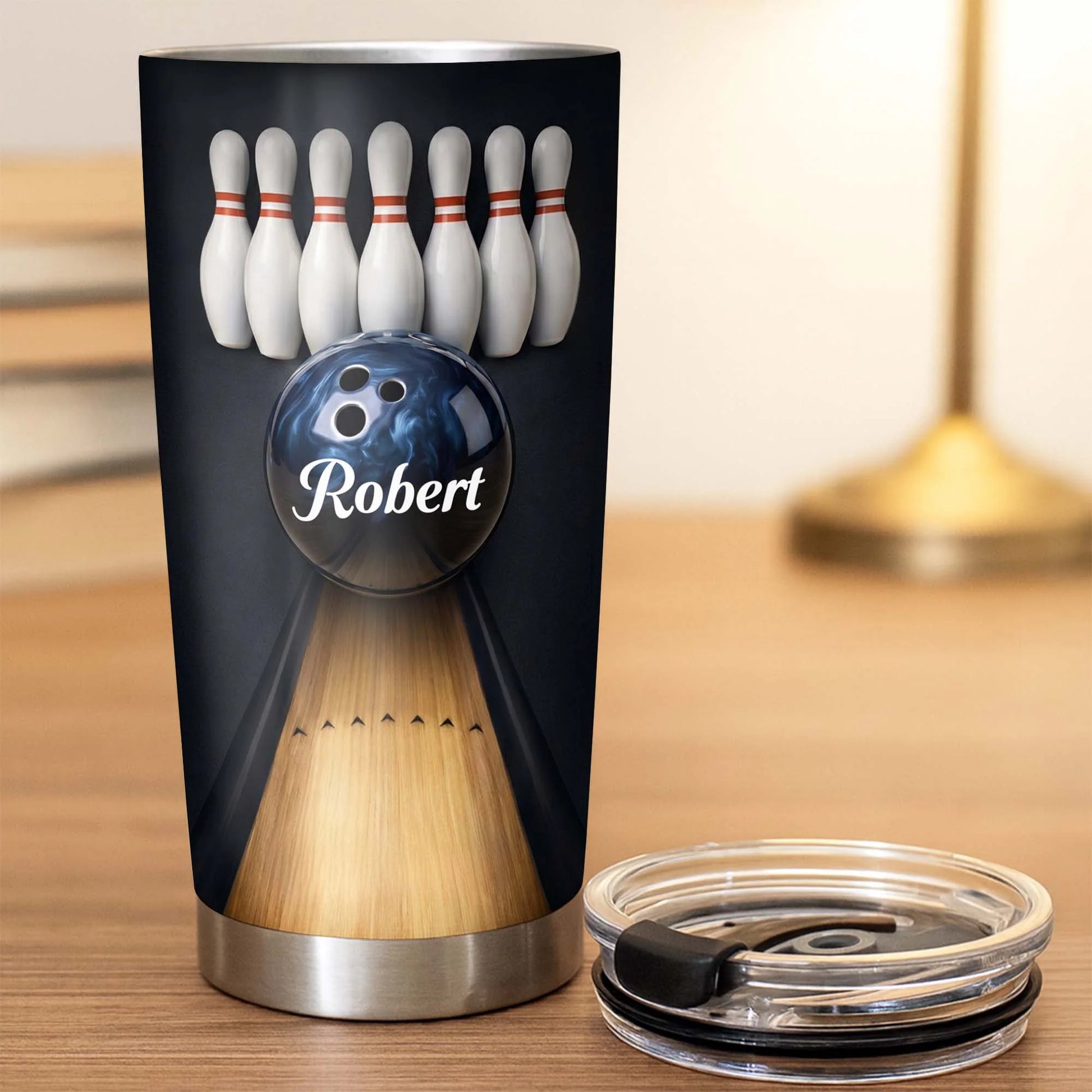 Personalized bowling tumbler with a custom name printed on a blue bowling ball with bowling pins and lane