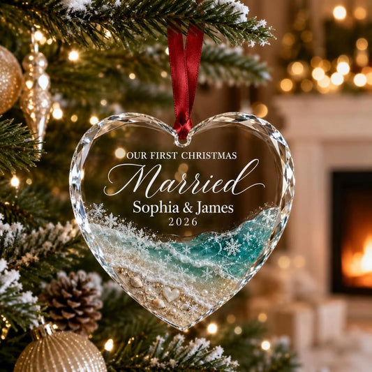 Personalized first christmas married ornament featuring glass heart with beach waves design for couples