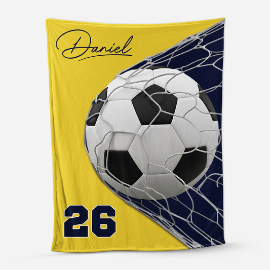 Personalized soccer blanket featuring a custom name and jersey number with a soccer ball hitting the net design