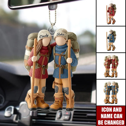 Custom hiking couple ornament featuring personalized names on two backpackers hanging in a car mirror.