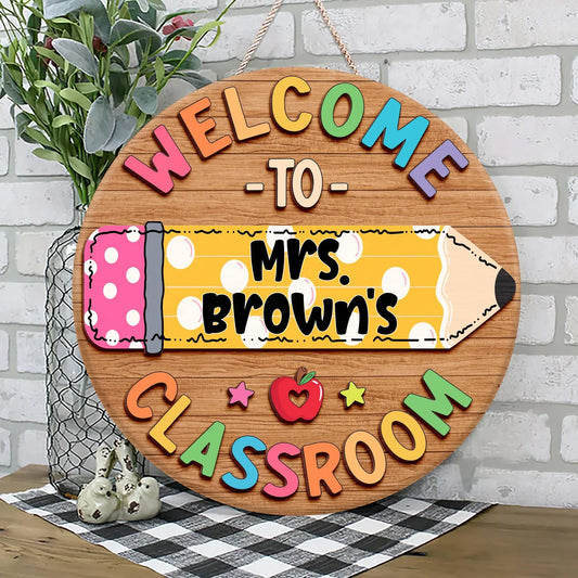 Personalized teacher classroom sign featuring a colorful pencil design with custom name on a round wooden door hanger