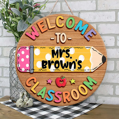 Personalized teacher classroom sign featuring a colorful pencil design with custom name on a round wooden door hanger